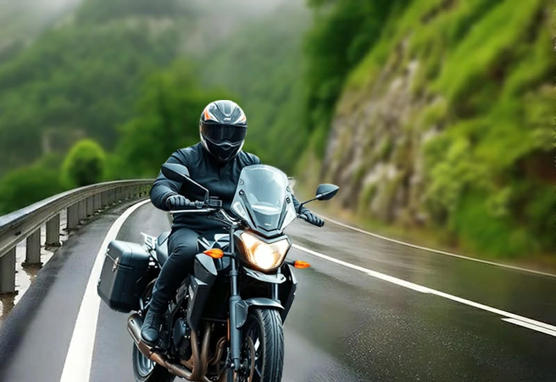 Motorcyclist driving at low speed on slippery mountain road